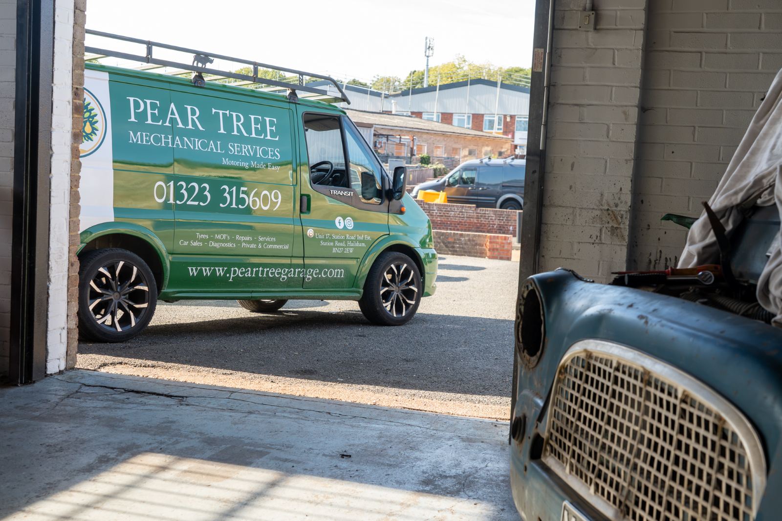 The Pear Tree Garage van seen through the workshop door