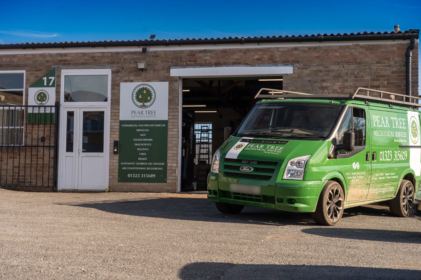 Unit 17 on Station Road Industrial Estate, with the Pear Tree sign beside the door and the garage van outside