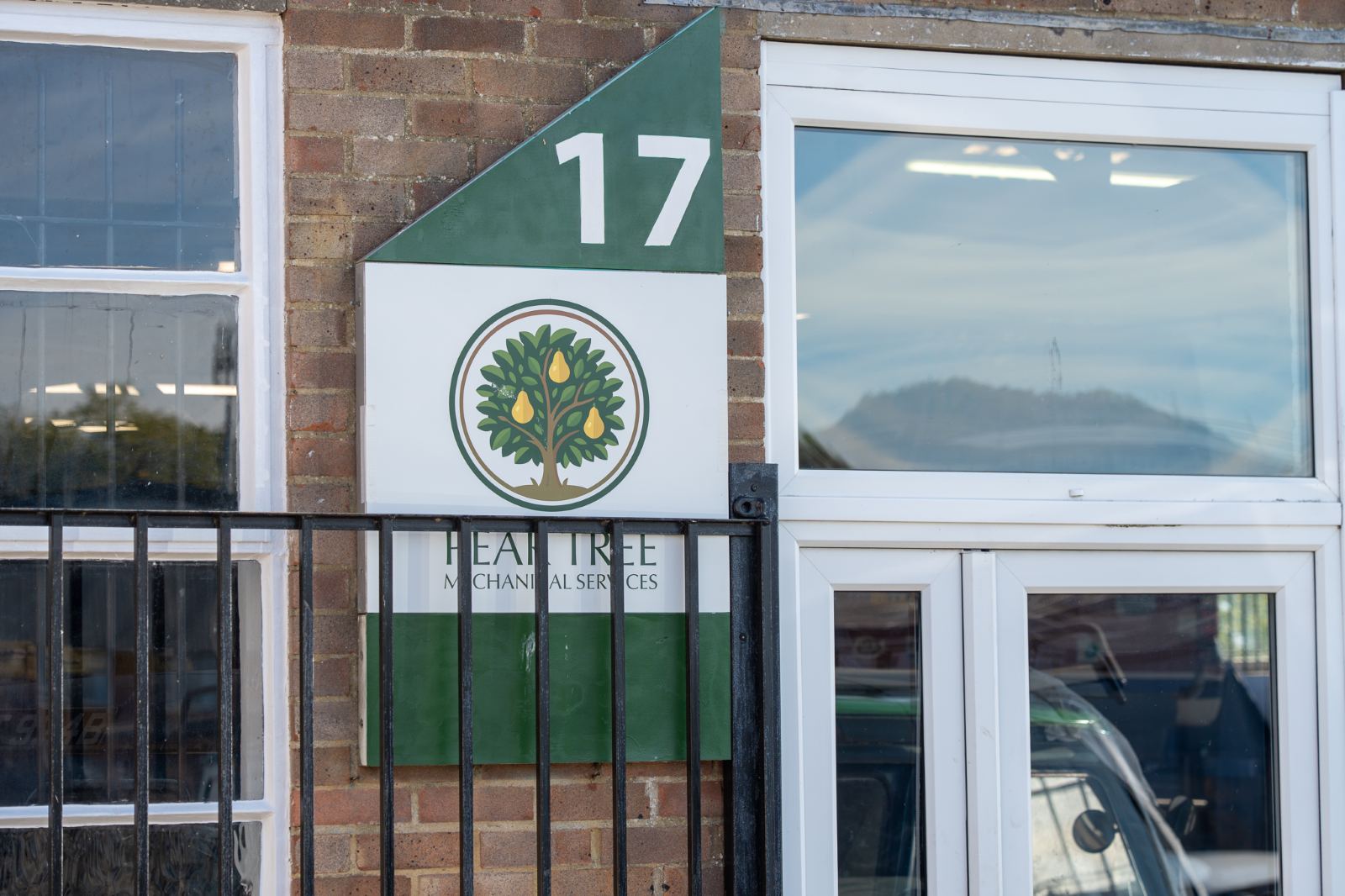 The green number 17 and the Pear Tree logo beside the workshop door