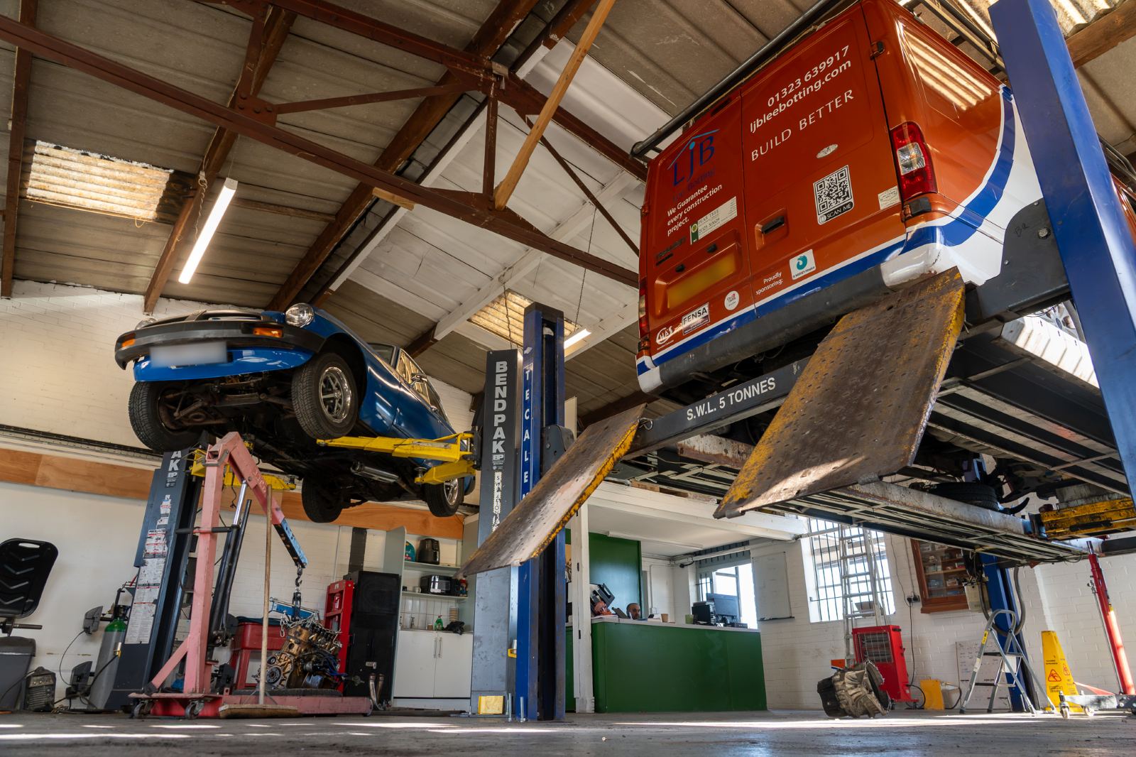 The Pear Tree Garage workshop, with a classic MG and an LJB van up on the lifts